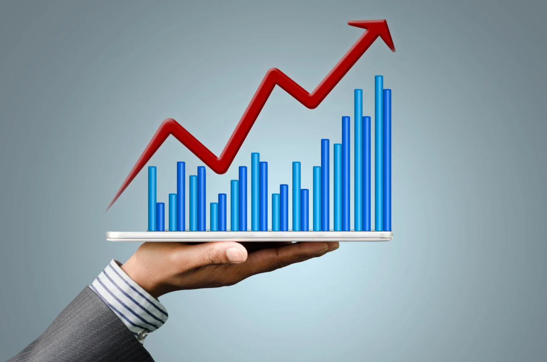 Professional hand holding tablet displaying blue bar chart with red upward trending arrow showing conversion rate optimization growth